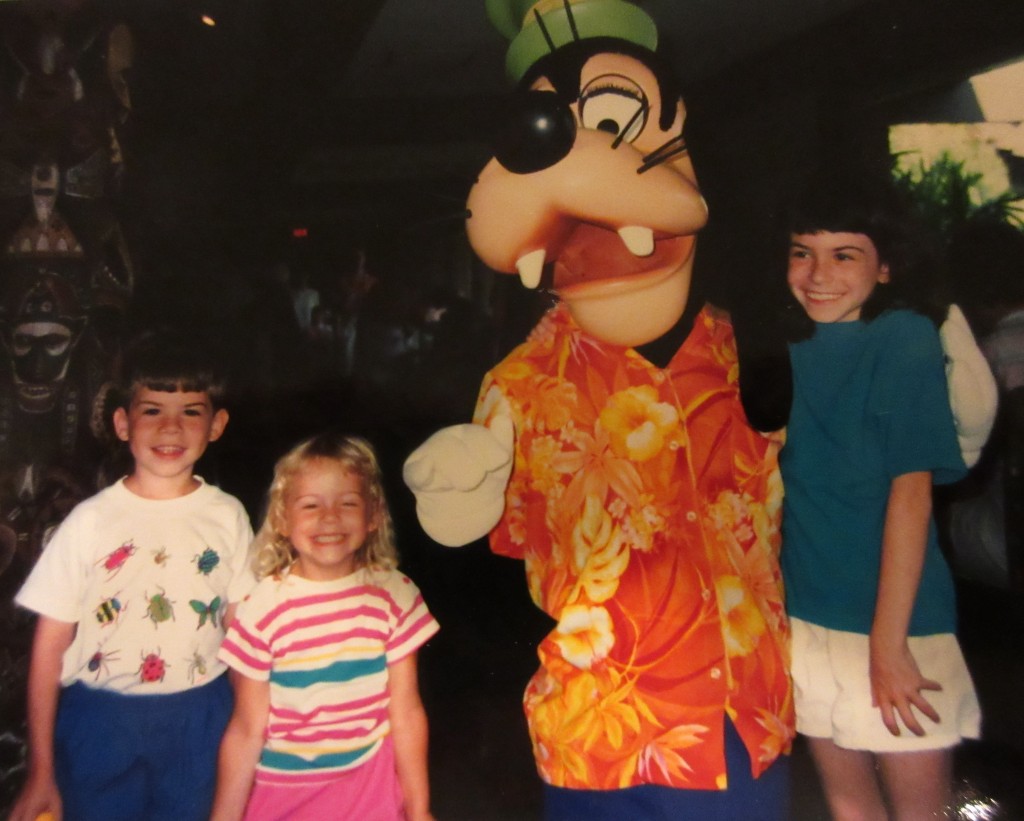 Three kids (the blogger and her siblings) with Goofy at Disney World in 1991.